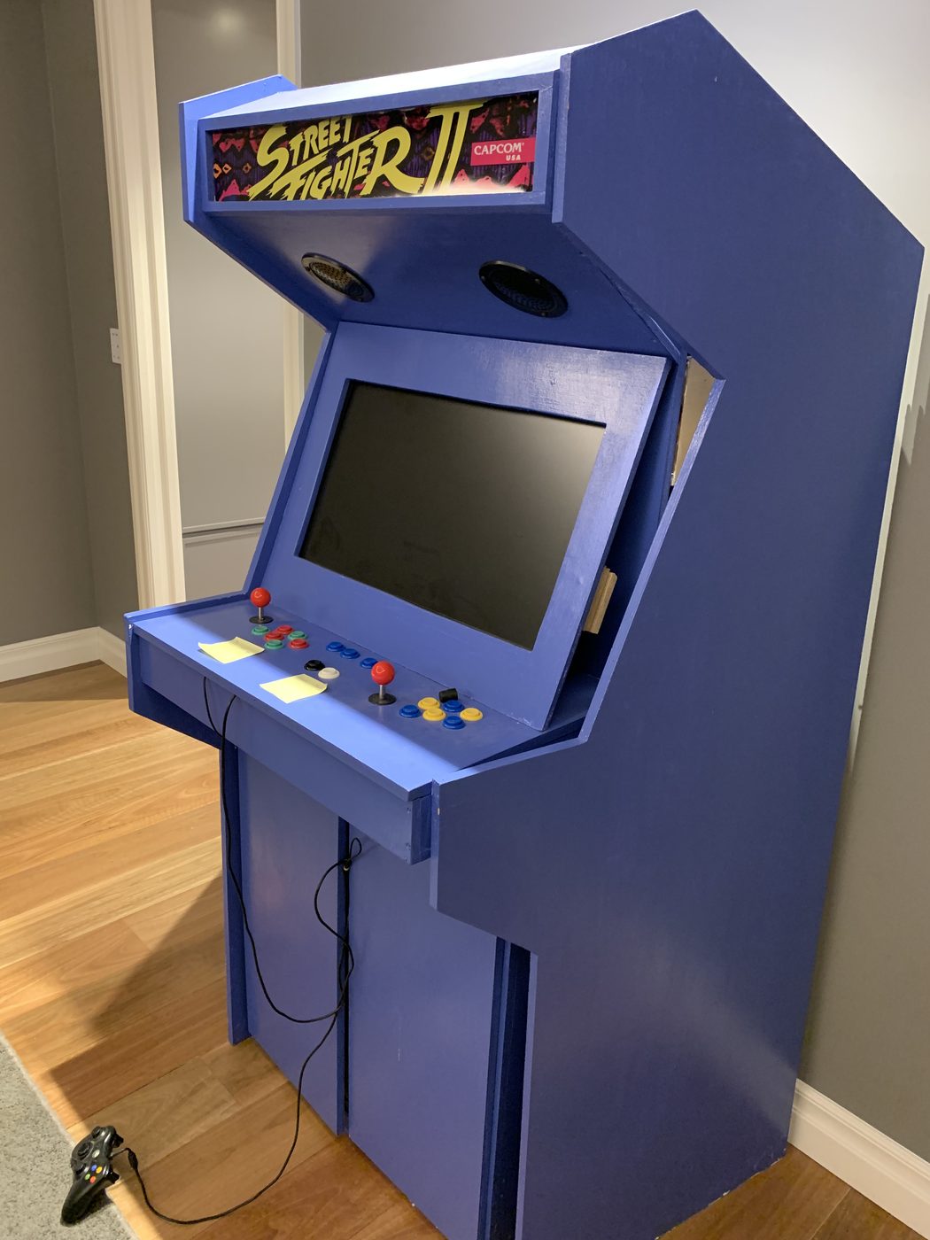 The finished custom retro arcade cabinet, lit up